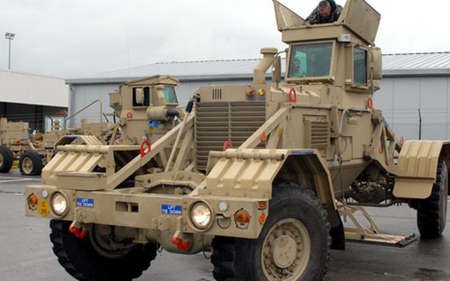 Jay Hanna, top of photo, a field service representative and new-equipment trainer with Critical Solutions International, helps Spc. Jennifer Bach, 25, of Belleville, Ill., become familiar with driving a Husky at Hohenfels, Germany.