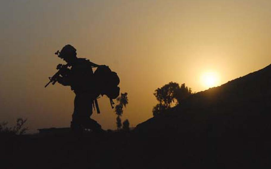 Spc. Hiram Elizondo crosses the steep banks of a canal early Saturday morning while searching fields around Samood, Iraq, for weapons caches. Soldiers with Fox Troop, 2nd Squadron, 3rd Armored Cavalry Regiment awoke at 4 a.m. to start patrolling before the worst of the heat arrived. But even Iraq’s coolest temperatures can be strength-sapping, especially when soldiers must lug all their gear on their backs.