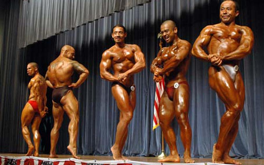 Competitors flex and pose during the pose down portion of the middleweight finals of the Central Japan Bodybuilding and Figure Championship at Yokota Air Base on Sunday. About 500 spectators came out the cheer on the 53 competitors who flexed, stretched and posed for the crowd.