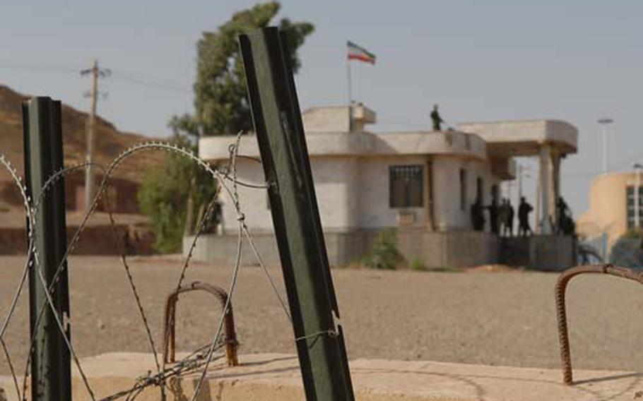 Barbed wire and cement barriers separate an Iranian building from Iraq at a border crossing near Khaniqin, Iraq. Despite the barriers, Iranian and American soldiers exchanged small talk through the gates that separate the two countries.