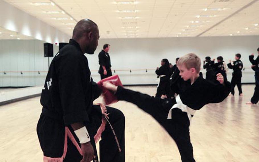 Max Blanchard, 6, gives the pad a well-placed kick during the Lakenheath Kuk Sool Won team's class last week. The team recently took top honors at an all-Europe tournament for the second year in a row.
