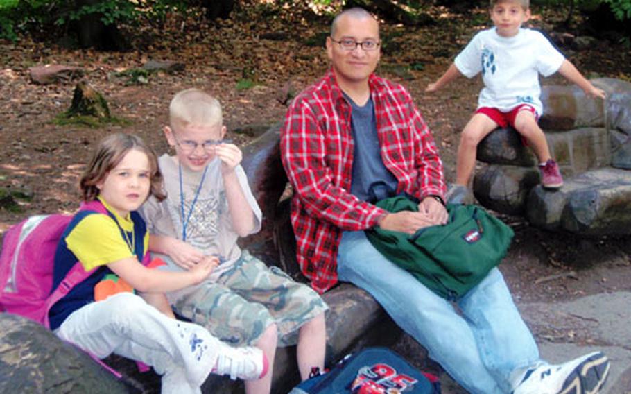Brianna Burgstrom, Cody Minor, Sgt. Roberto Villaran and Lucas Howard take a break during a hike on a nature trail in Königstuhl, Germany. Twenty childen took part in a camp offered last week by Mannheim’s Army Community Services. The camp was paid for using Army Family Covenant funds.