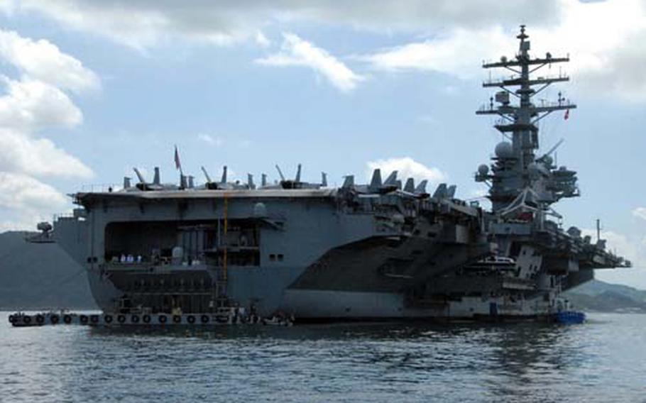 The USS Kitty Hawk pulls into Pearl Harbor on Tuesday after participating in the Rim of the Pacific exercise, the ship's last exercise before its scheduled decommissioning.