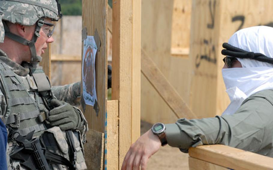 Platoon leader 2nd Lt. Alex Myer, 23, of Medford, Ore., questions an "Iraqi villager" at Grafenwöhr Training Area on Thursday.