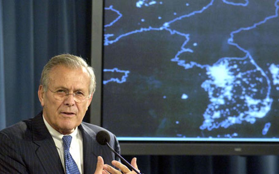 Defense Secretary Donald H. Rumsfeld addresses a reporter's question about the significance of the reported North Korean nuclear test during a Pentagon press briefing, Oct. 11, 2006. As part of his response, he showed reporters a satellite view of the Korean peninsula taken at night.