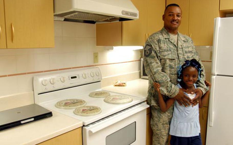 Master Sgt. Dexter Coburn stands with daughter Desiree in the remodeled kitchen of his H-style military family house at Misawa Air Base, Japan. Coburn's house is one of 126 housing units refurbished so far at Misawa since January 2007. More units on both main base and the north area are scheduled for renovations over the next several years.