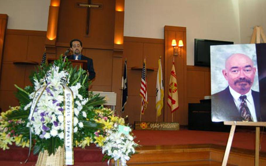 Tony Gray, talks about long-time garrison employee John Wood during a memorial service Monday at Yongsan Garrison. Gray was a longtime friend of Wood, who directed the garrison’s music and theater program since 1998 until he died from a sudden illness and subsequent heart failure July 23.