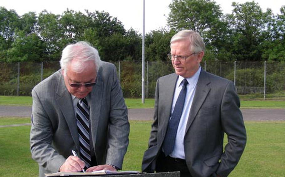 Gary Moncur, left, pauses to sign the guest book at the 303rd Bomber Group memorial at RAF Molesworth this summer while his brother Marlowe looks on. Their father, 1st Lt. Vern Moncur, piloted the Flying Fortress across Nazi-occupied Europe during World War II.