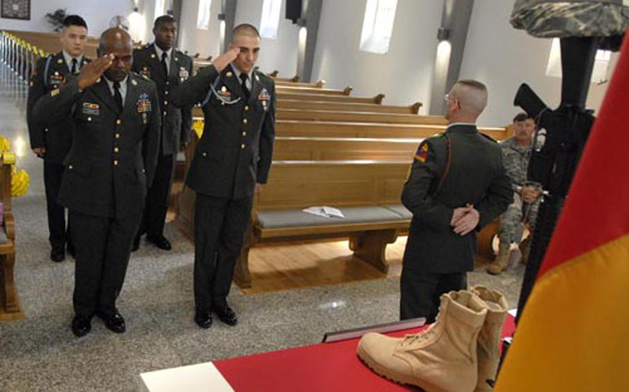 Soldiers pay their respects to Sgt. James A. McHale during a memorial ceremony Tuesday at a chapel in Baumholder. McHale, 31, a soldier assigned to the 40th Engineer Battalion died July 30 from wounds he received when a roadside bomb detonated near Nahrawan, Iraq, on July 22.