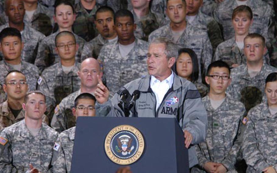 President Bush delivers a motivational speech Wednesday to a gym full of servicemembers at Yongsan Garrison, South Korea.