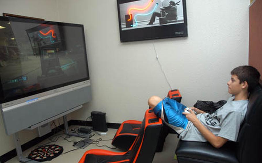 Sean Rogers, 13, plays a video game Wednesday in the new teen center at Camp Courtney, Okinawa. The center opened last month.