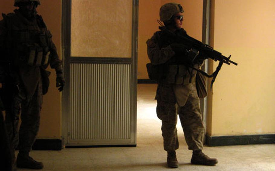 Marines with 2/11 Civil Affairs Detachment 3, Regimental Combat Team 1, provide security during a visit Monday to a medical clinic being set up in Karmah in Anbar province, Iraq.