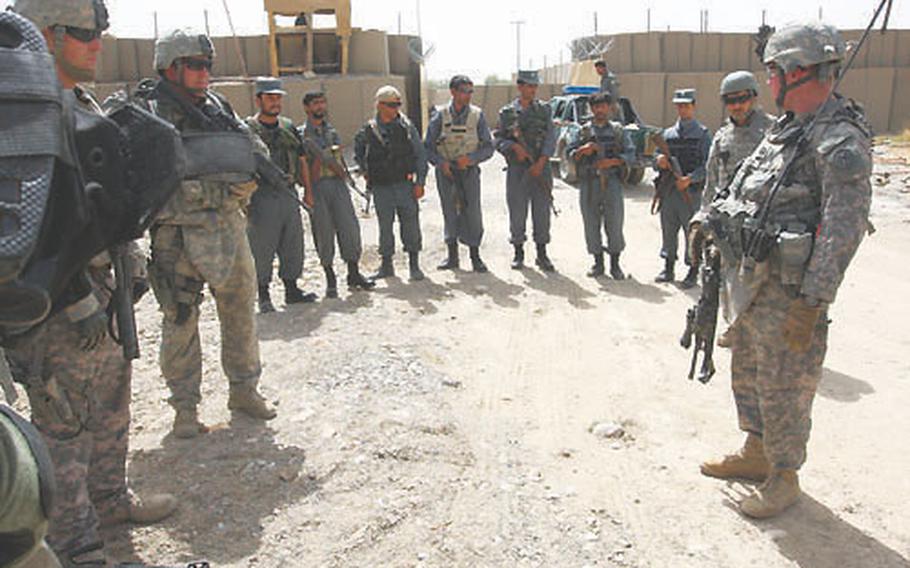 U.S. troops from Task Force Crazy Horse, comprised mainly of soldiers from the 27th Brigade, New York Army National Guard, prepare for a patrol with Afghan police in Maiwand, Afghanistan.