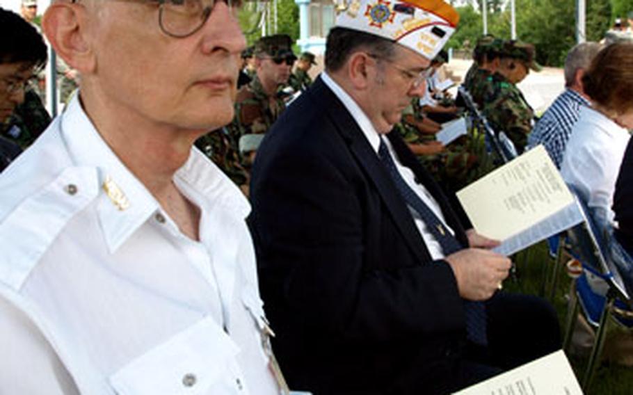 Members of VFW Post 8180, the Bonifas-Barrett Memorial Post from Seoul, watch the memorial to Capt. Arthur Bonifas and 1st Lt. Mark Barrett at the Demilitarized Zone in Korea on Thursday. The two soldiers were attacked and killed by North Korean soldiers in 1976.