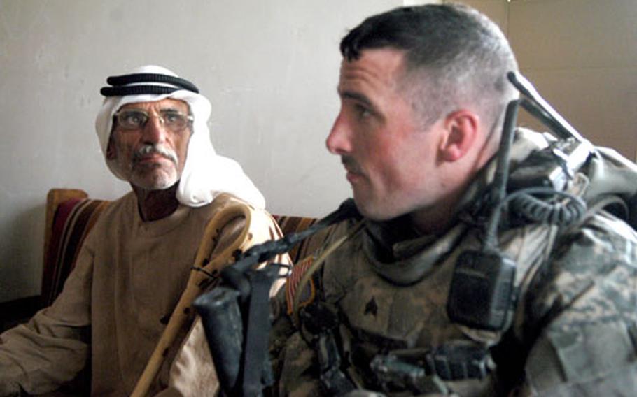 Sgt. Kyle McNeal, 28, from Minnesota's 407th Civil Affairs Battalion, listens to complaints about a recent security operation by Iraqi National Police in villages south of Baqouba. Al Abarra's mukhtar, or leader, Abud Al Wahed Hussein Muhammed, sat next to McNeal in the village's Iraqi Police station on Wednesday.