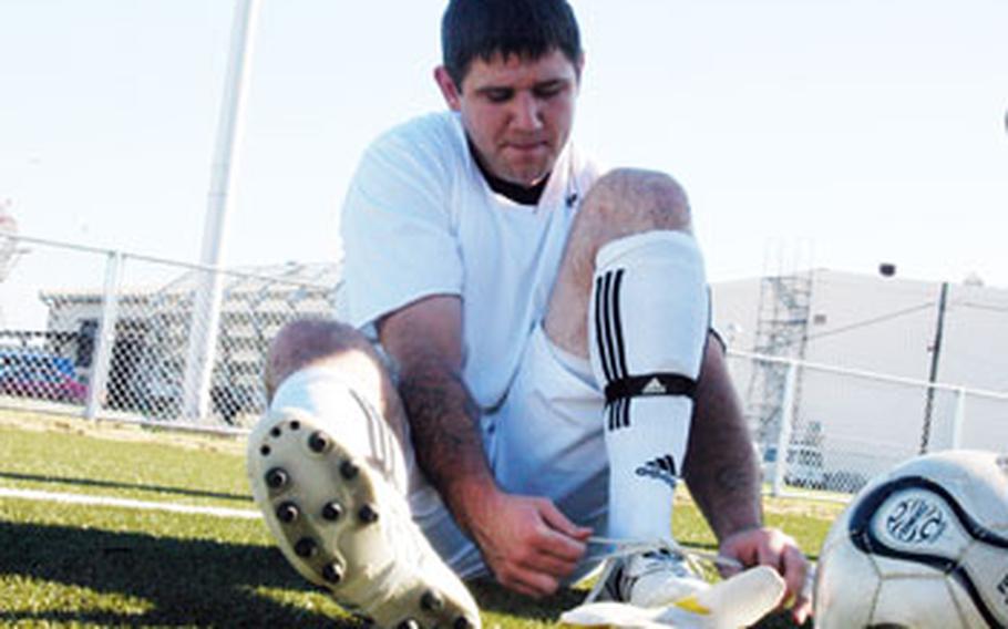 Petty Officer 1st Class Charles Blakely laces up for the first soccer match on Yokosuka Naval Base’s Berkey Field in August 2007.
The artificial surface is considered too new to worry about lead dust in the synthetic turf, base officials said Monday.