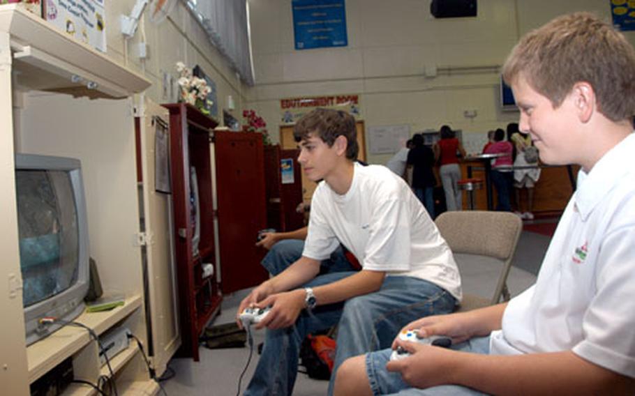 Samuel Niblack, left, and Alex Dressel, both 13, play “Call of Duty 2” at the Teen Center on Kadena Air Base, Okinawa.