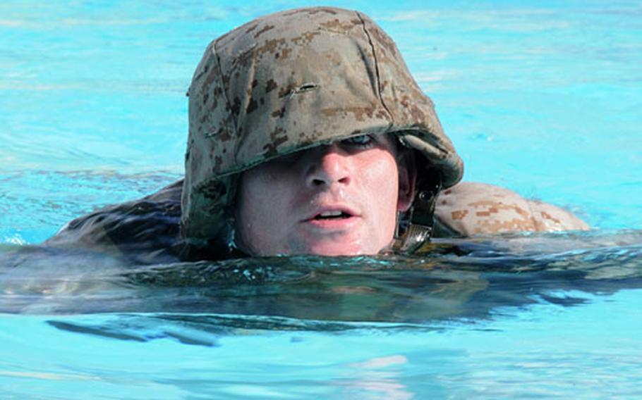 Cpl. Shane Brown, 21, from Huntsville, Utah, with Combat Logistics Squadron 37, swims 50 meters wearing his helmet, flak gear and a rubber rifle as part of a screening process for the U.S. Marine Corps Forces Special Operations Command.