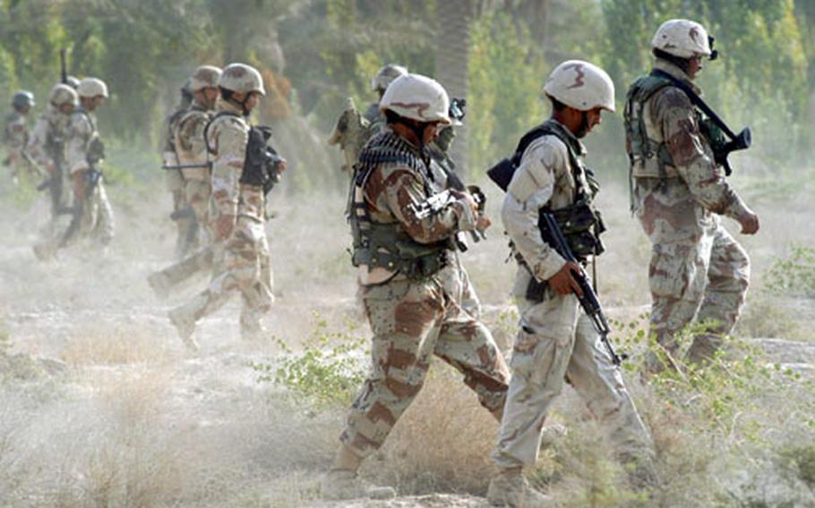 Soldiers with the 1st Brigade, 1st Iraqi Army Division, kick up dust as they search for weapon caches in a field during an Iraqi-led offensive north of Baqouba.