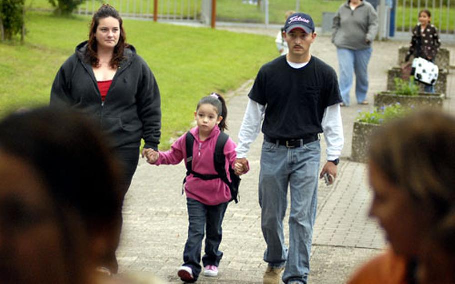 Arionna Stevens, a first-grader at Wetzel Elementary School in Baumholder, Germany, walks to school Monday with her parents, Spc. Martin and Crystal Stevens. Martin Stevens is assigned to 1st Battalion, 35th Armor Regiment.