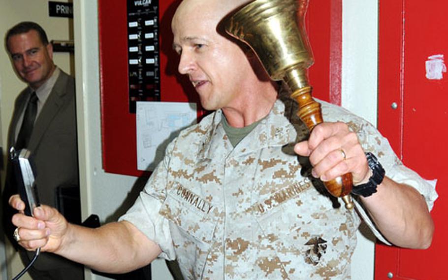 Col. Tom Connally, Headquarters Battalion, 3rd Marine Division, commander and camp commander for Camps Courtney and McTureous, rings in the new school year Monday at Bechtel Elementary School on Camp McTureous.