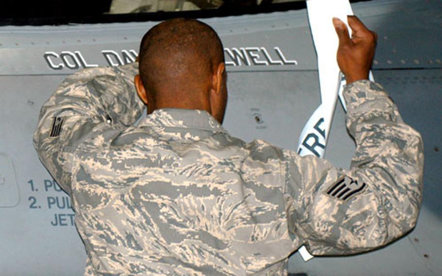 Staff Sgt. Jevon Hairston, the 35th Fighter Wing's dedicated crew chief, switches the name on the wing commander's F-16 to reflect the change in leadership at Misawa Air Base, Japan. Col. David Stilwell took command of the wing and the base Monday from Col. Terrence J. O'Shaughnessy.