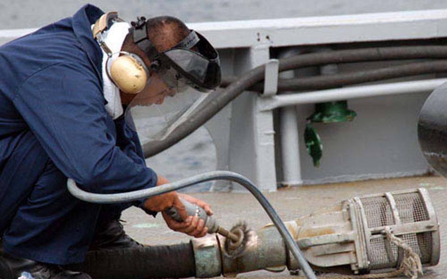 The average age of Yokosuka's tugboats is 42 years old; Petty Officer 3rd Class Paul Taborada worked on keeping the equipment looking new last week.