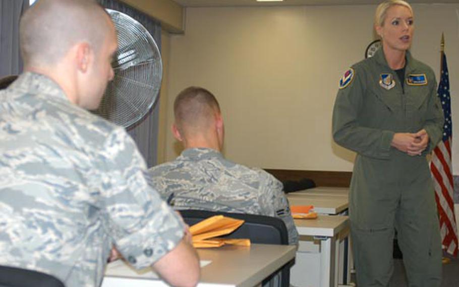 Capt. Erin Fager speaks to airmen new to Misawa Air Base, Japan, on Tuesday about sleep deprivation and being careful about buying nutritional supplements off-base. Fager, 27, is the chief of the base's human performance training team. She aims to help airmen eliminate human error by educating them on health, situational awareness and other issues.