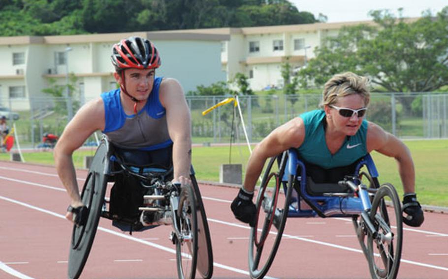 U.S. Paralympic athletes Tyler Byers, 26, from Spokane, Wash., and Cheri Blauwet, 28, from Larchwood, Iowa, train at the Ryukyu Middle School track on Kadena Air Base on Wednesday. The U.S. Paralympic swim and track teams arrived on Okinawa on Sunday to prepare for the Paralympic Games, which begin Sept. 6 in Beijing.