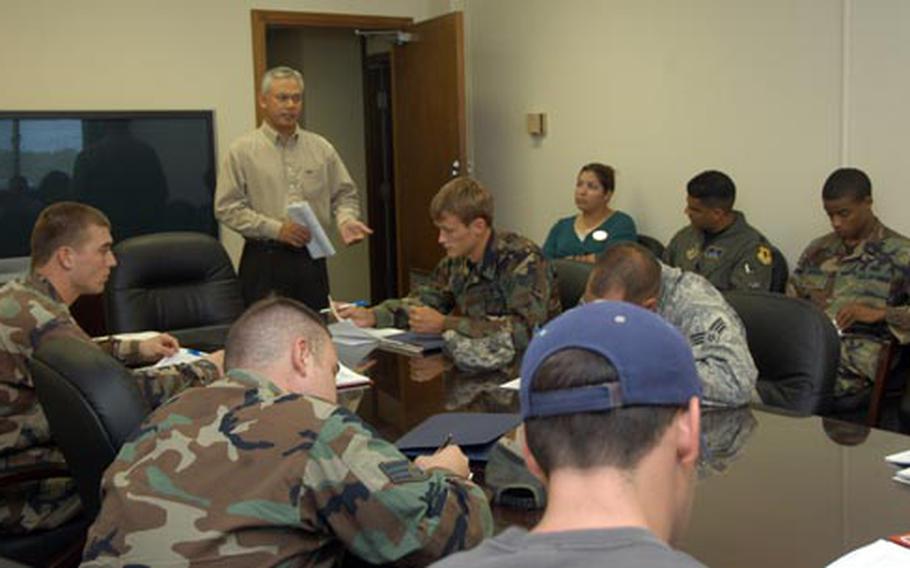 Air Force Community Readiness consultant Joe Catahay leads a pre-separation briefing Thursday at Kadena Air Base, Okinawa. The briefing is a mandatory orientation before attending the transition assistance workshop.