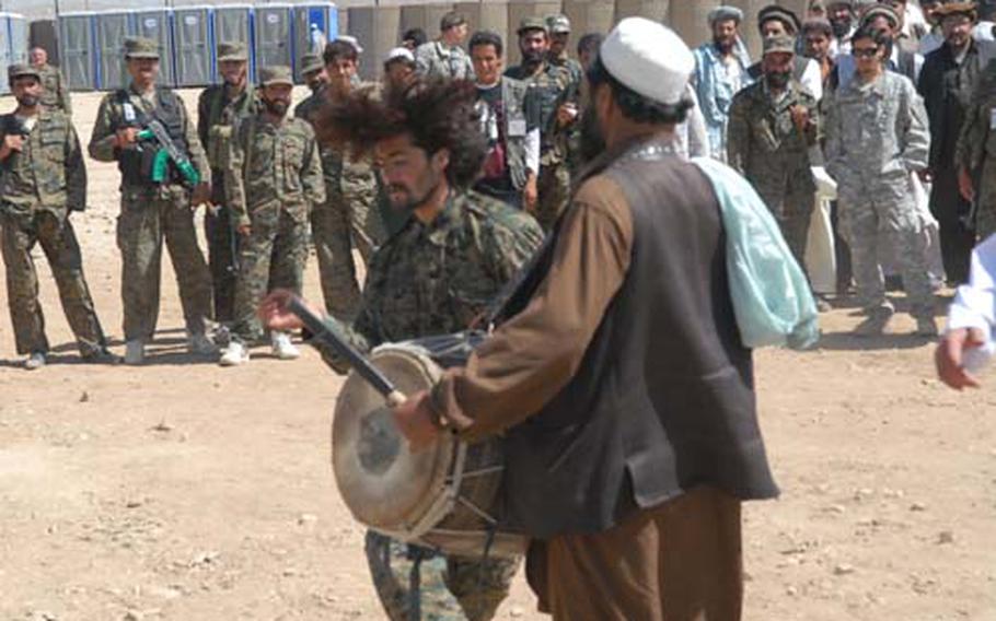 An Afghan soldier performs a hair-flinging twirl dance after a U.S. organized meeting of tribesmen in eastern Afghanistan.