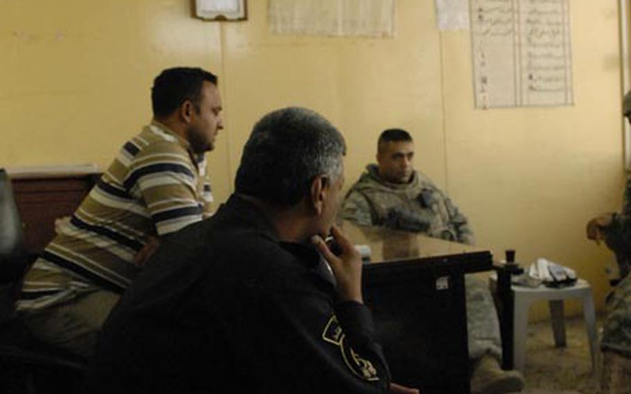 Sgt. 1st Class Carmen Centennial (right) listens as workers at the Abu D’shir gas station talk about recent challenges with workers and customers. Col. Brahim Mihsson Jassim (front), the member of Iraq’s directorate for oil police assigned to the station, said he has worked to cut down on corruption and theft there.