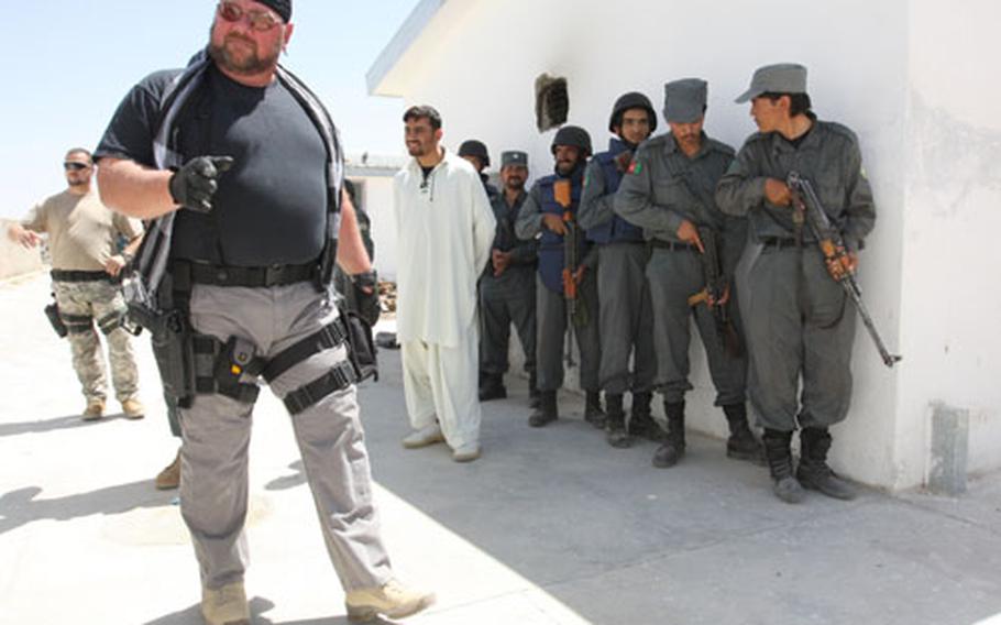 Rich Garner, a police adviser with the U.S. security firm DynCorp, instructs Afghan police during a training session on room-clearing techniques near Qalat.