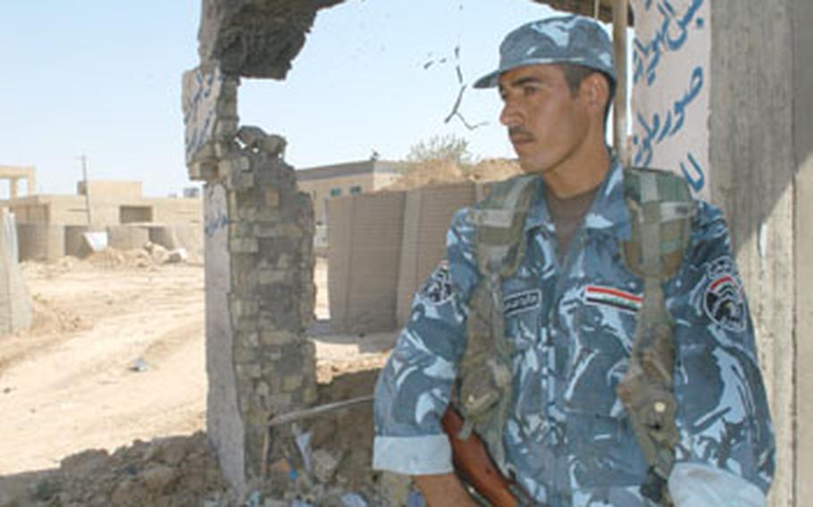 Iraqi policeman Zuher Kader al-Kerwii guards the entrance to Jalula’s Emergency Response Force police station, which was attacked last week.