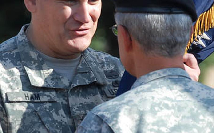 New United States Army Europe and Seventh Army commander Gen. Carter Ham takes the USAREUR colors from Gen. John Craddock, commander, United States European Command at the USAREUR assumption of command ceremony in Heidelberg on Monday.