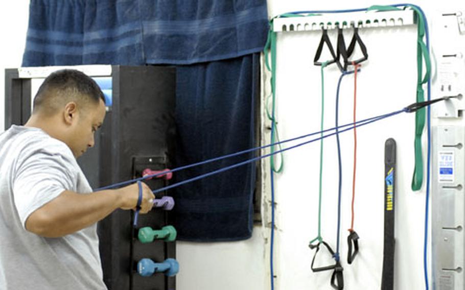 Staff Sgt. Juan Cruz of the 2nd Stryker Brigade Combat Team, 25th Infantry Division works his shoulder muscles at Camp Taji’s physical therapy clinic on Friday. Cruz hurt his shoulder falling from a vehicle last month. Most of the shoulder injuries therapists are seeing come from wearing body armor improperly and poor weight-lifting technique.