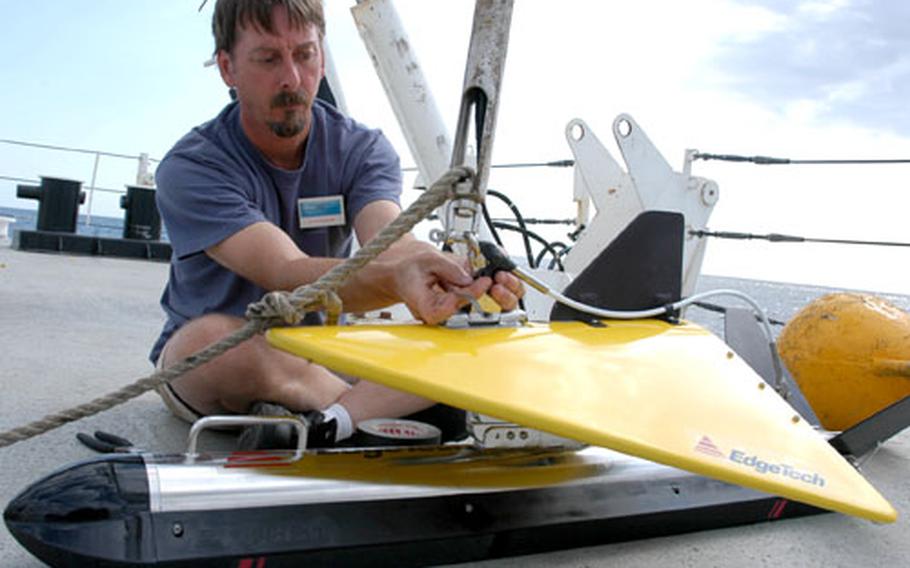 Dave Wright, an engineer with the Institute for Exploration, prepares a side scan sonar for launch this week during a demonstration aboard the USNS Pathfinder in the Black Sea. The side scan sonar uses sound pulses on the ocean’s floor to locate possible shipwrecks.