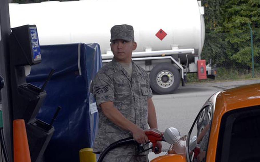 Air Force Staff Sgt. Jason David, an American Forces Network producer, uses his new fuel ration card to gas up at Vogelweh last Friday. The cards are replacing the gas ration coupons gradually across Germany.