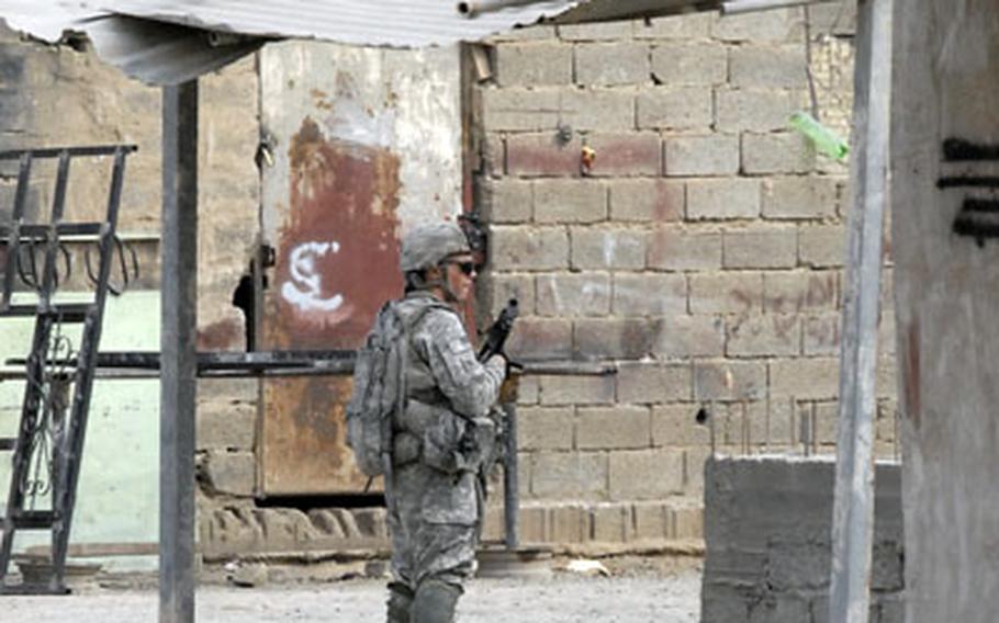 Pfc. Tyler Frame of the 1st Battalion, 14th Infantry Regiment guards an alleyway during a patrol on the city of Tarmiyah Tuesday. The area has been the target of several al-Qaida in Iraq attacks in recent days.