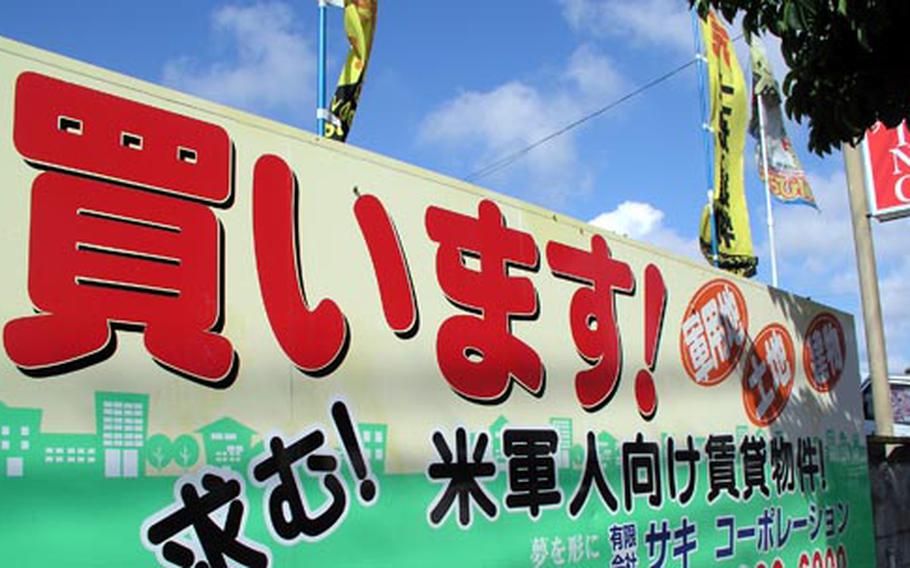 This sign posted in front of a realtor office near Kadena Air Base reads; “Buy – military land, land and buildings.”