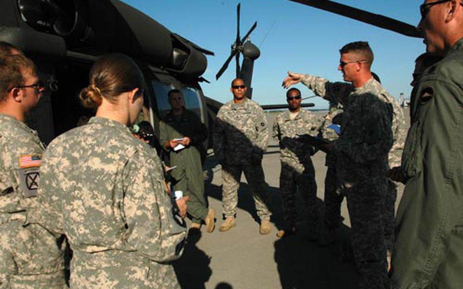 Members of Camp Zama's 78th Aviation Battalion conduct a pre-mission brief before conducting door gunnery qualification at the Misawa Air Base range.