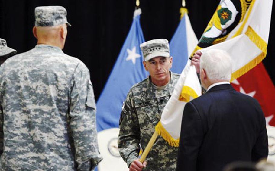 Gen. David Petraeus hands the Multi-National Force Iraq flag to Defense Secretary Robert Gates, while Gen. Ray Odierno stands on the right, during a Change of Command ceremony at camp Victory in Baghdad, Iraq, Tuesday, Sept. 16, 2008. David Petraeus, the American general who presided over Iraq's pullback from the brink of all-out civil war, relinquished his command Tuesday to Gen. Ray Odierno.