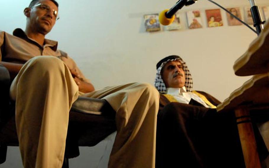 Sadek Ibrahim Al Koreshi (left) and Mohammad Hussein Hamad Jabouri wait for a radio program to begin Wednesday so they can discuss work they’re doing to help their neighborhoods.