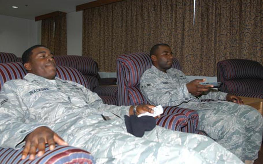 Airmen 1st Class Marquis Blacksher, left, and Demarcus Harris relax in the "movie room" in the newly renovated Air Force dormitory next to the Mokuteki Community Center at Misawa Air Base, Japan.
