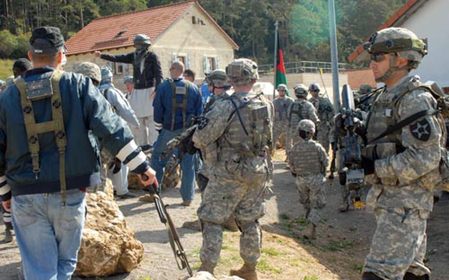 Members of 3rd Stryker Brigade, 2nd Infantry Division deal with a group of role players pretending to be angry townfolk during training at Hohenfels, Germany, on Friday.