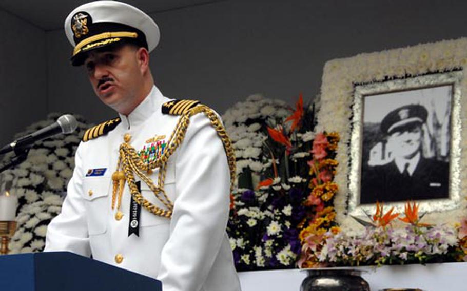 Capt. James Tranoris, Commander, Naval Forces Korea speaks in front of a photo of William Hamilton Shaw, a Korean-born U.S. Navy officer who died during the Korean War. A new memorial park will be built next year in Seoul to replace a small memorial to Shaw in a children's playground.