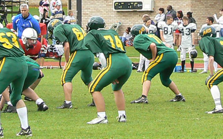 Danika Wilson, No. 74, with arms crossed at left, takes to the field for the first time at the U.K. high football jamboree at RAF Lakenheath earlier this month.