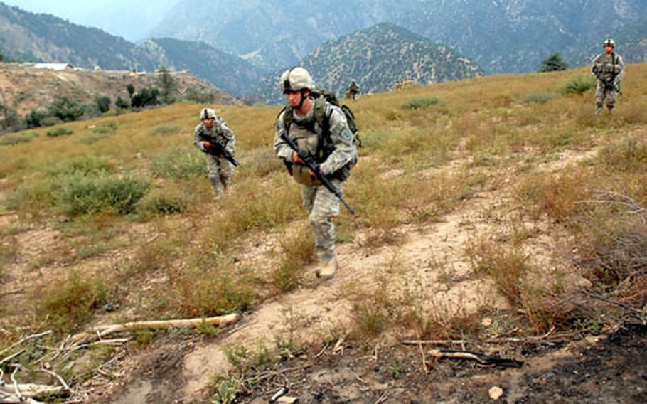 Soldiers from 1st Platoon, Troop C, 6/4 Cavalry Regiment during a patrol in northeastern Nuristan Province near the Pakistani border. Fire swept through the mountains here several years ago, reportedly set by Pakistani loggers aiming to eliminate their competition.