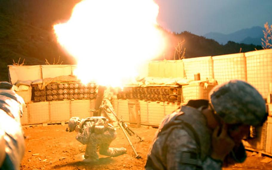 Sgt. Ken Dicristofano, front, ducks away from a mortar blast at Combat Outpost Lybert.