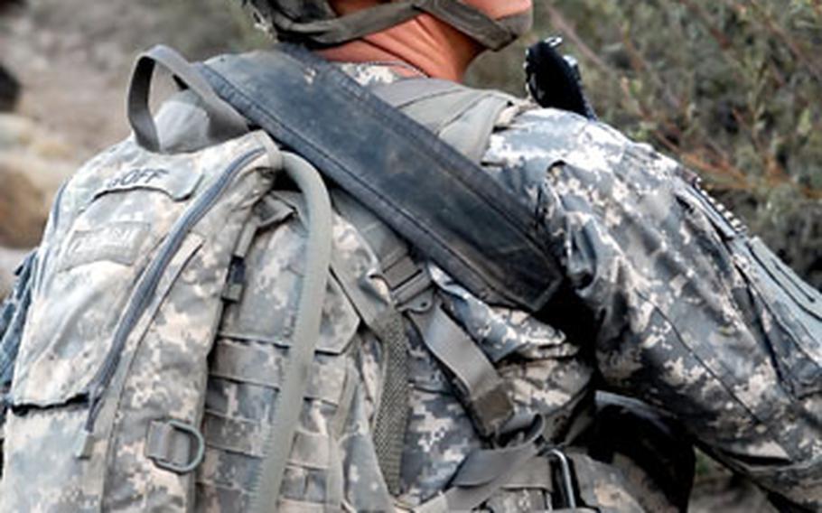 Pvt. Kirk Goff scans the surrounding hills during a patrol near Combat Outpost Lybert.